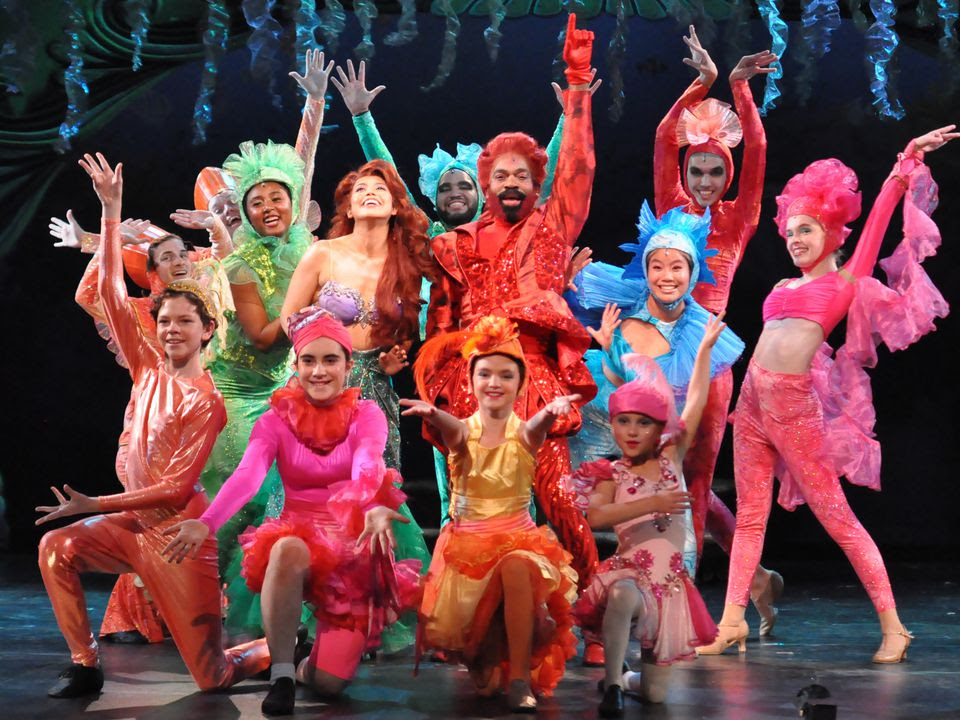 Kayla Shimizu as Ariel (center left) and Davron S. Monroe as Sebastian (center right) with the ensemble of "Disney's The Little Mermaid" at Reagle Music Theatre in Waltham. HERB PHILPOTT